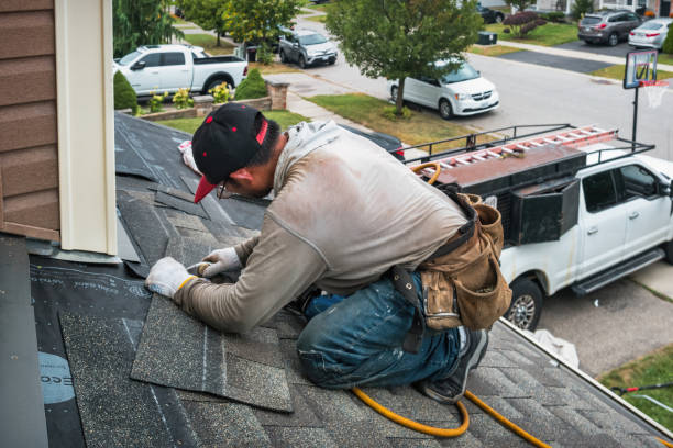 Professional Roofing technician working in Exira, IA